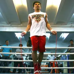 Boxers jump rope to build stamina and footwork. Manny Pacquiao trains in a boxing ring, surrounded by spectators.