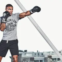 Boxer throws a punch, showcasing the power and benefits of punching with dumbbells for strength and conditioning.