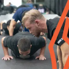 Boxers perform push-ups as part of their intense boxing stretches routine, building strength and endurance for the ring.