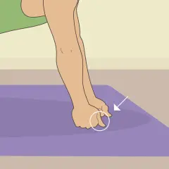 Close-up of hands performing a hand conditioning exercise on a purple mat, with an arrow pointing to the fingers.