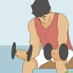 Man doing dumbbell wrist curls to learn how to get stronger wrists.