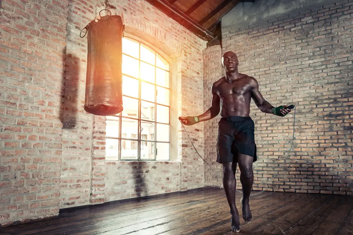A boxer jumps rope in a brick gym. Jump rope is good for boxing because it builds stamina, agility, and footwork.