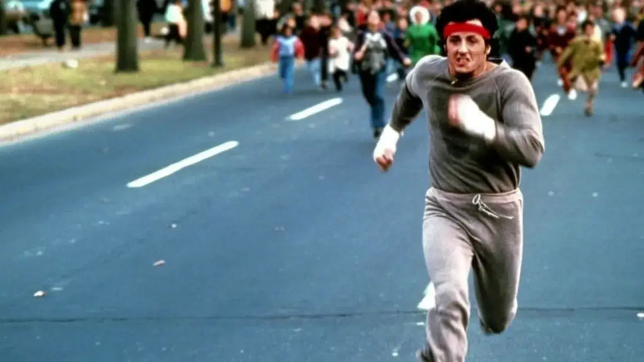 Rocky Balboa runs through a crowd, showing how many miles do boxers run for training.